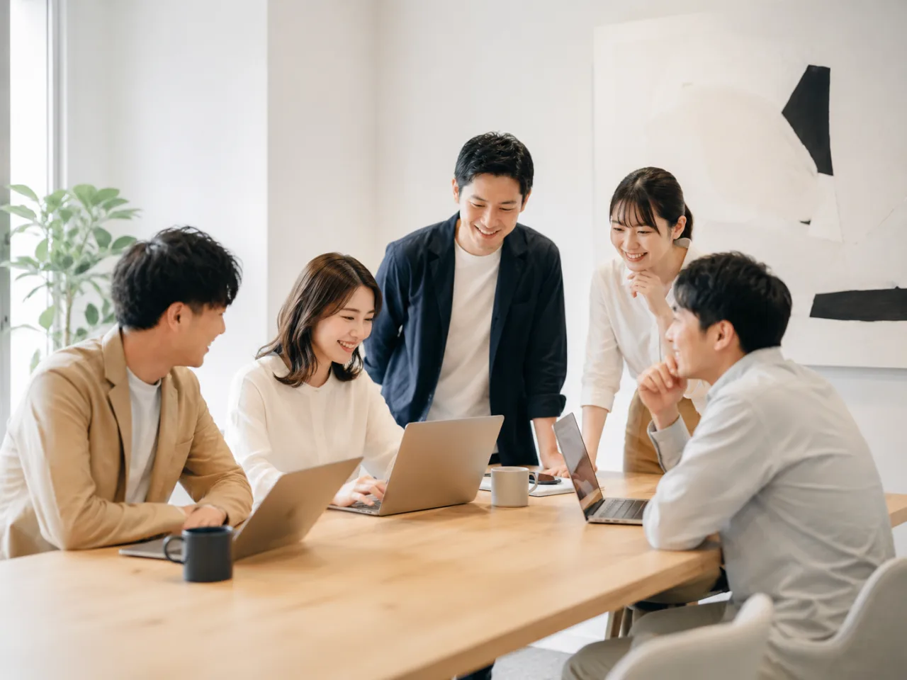 ノートPCを囲んで話し合う5人(イメージ画像・AI生成。DIRIGIOの実在のメンバーではありません)